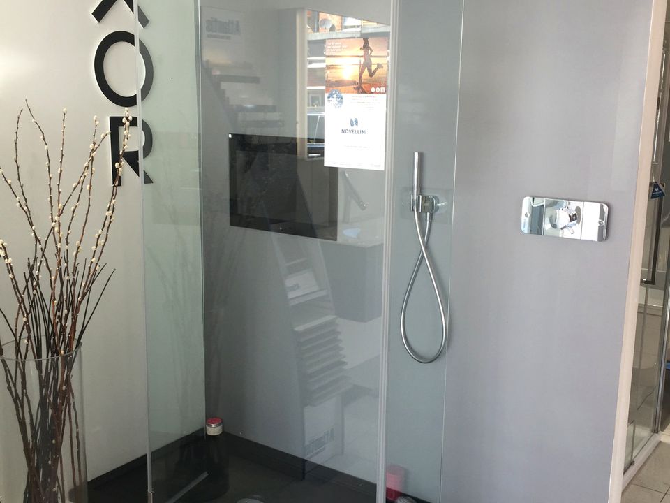 Walk-in shower enclosure with a slimline tray and glass panel