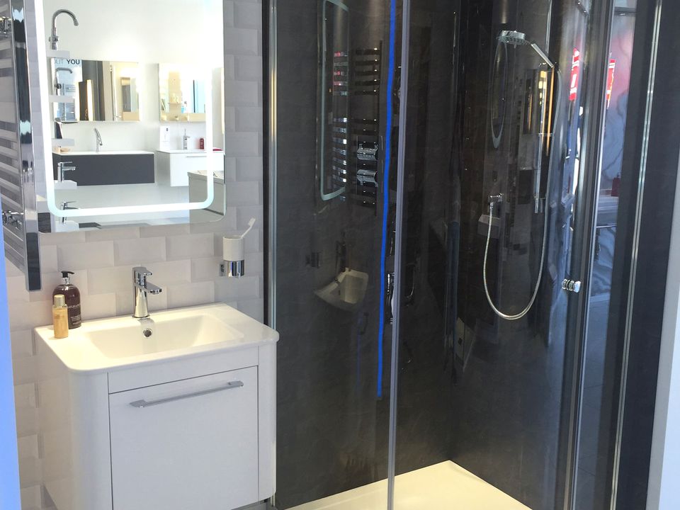 Walnut and dark grey bathroom furniture with a wall-hung WC in the showroom